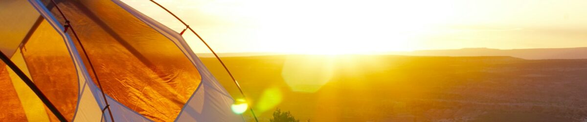 camping tent on cliff during golden hour